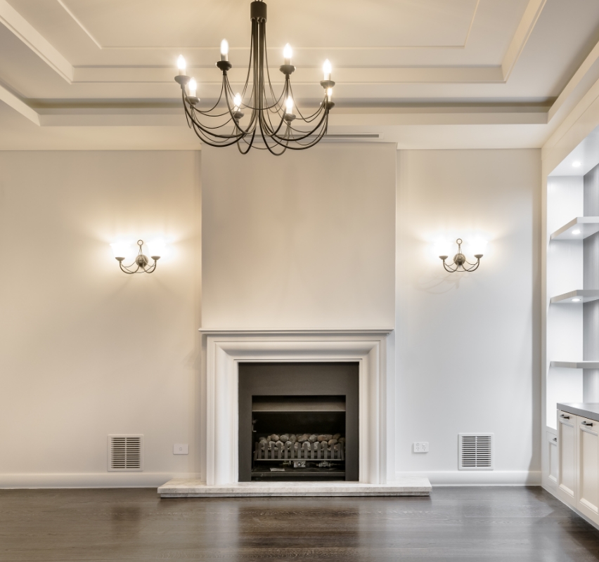 Elegant living room with fireplace and chandelier.