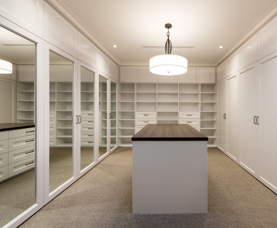 Modern walk-in closet with built-in shelves and island
