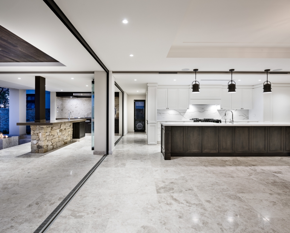 Modern kitchen with white cabinets and pendant lighting.