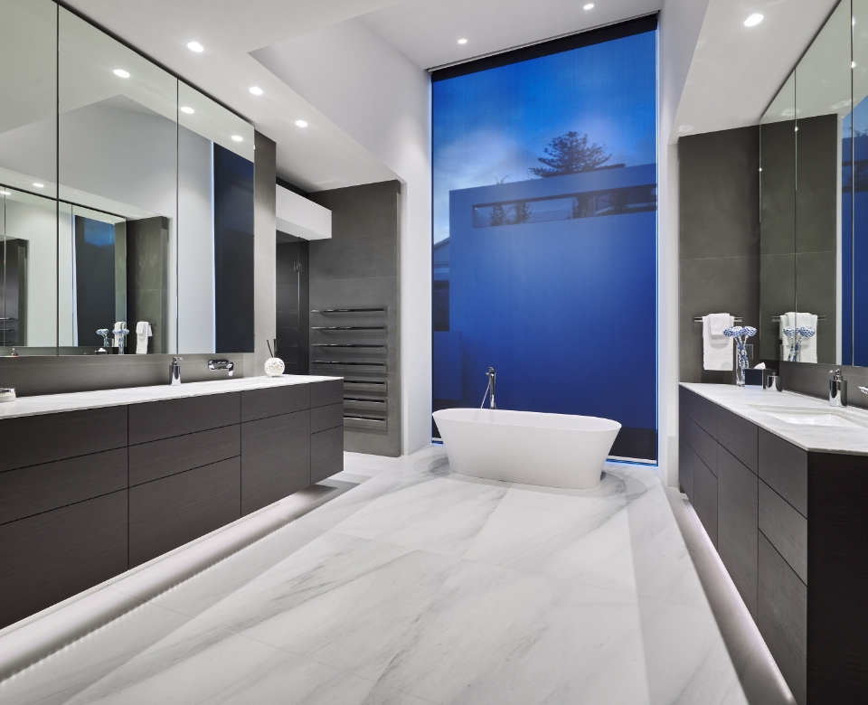 Modern bathroom with marble floor and blue accent wall.