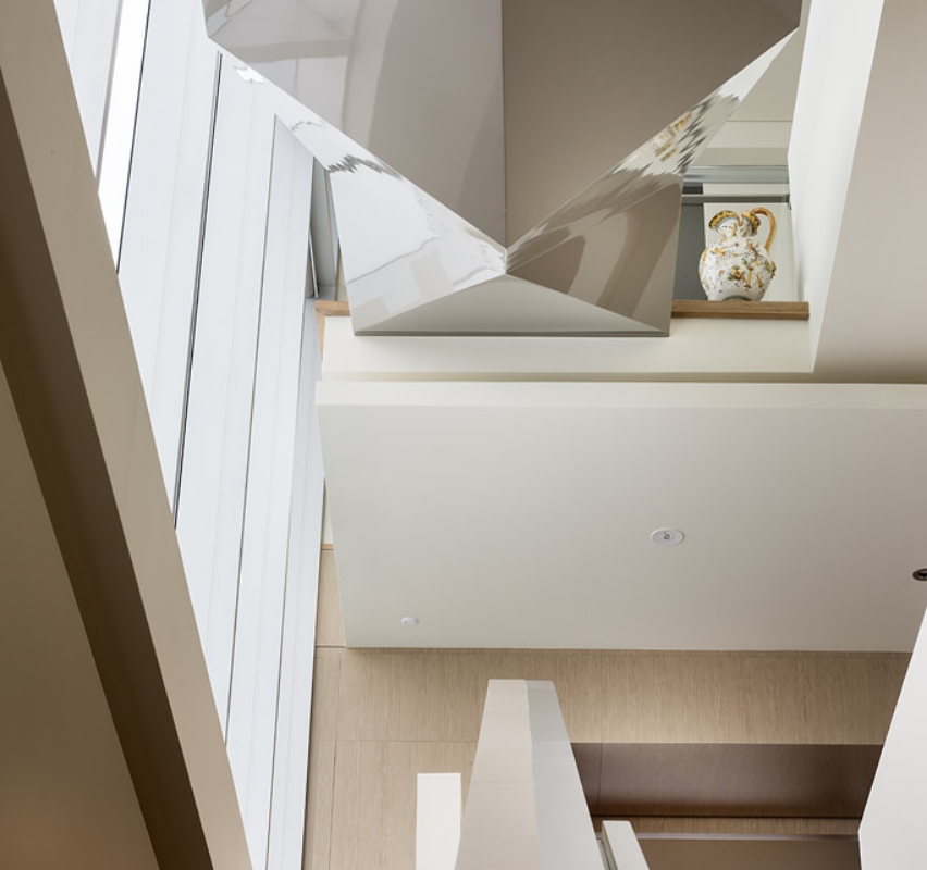 Modern interior staircase with unique geometric design.