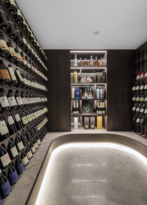 Modern wine cellar with illuminated shelves and selection.