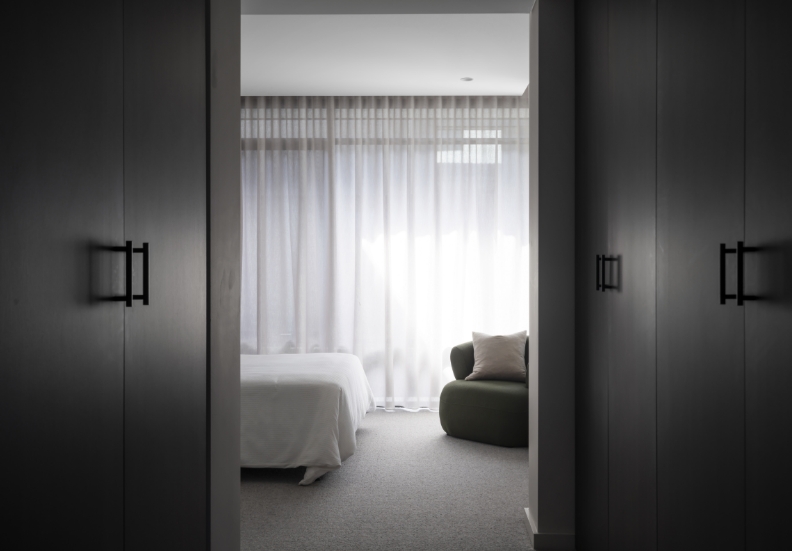 Modern bedroom with natural light and minimalist design.