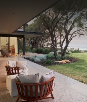 Ocean view patio with garden and outdoor furniture.