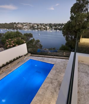 Riverside luxury home pool at dusk.