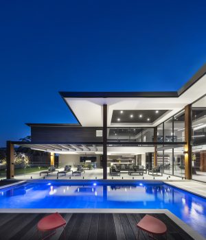 Modern house with pool at twilight.
