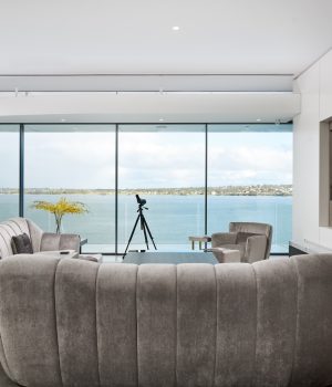 Modern living room with ocean view and elegant decor.